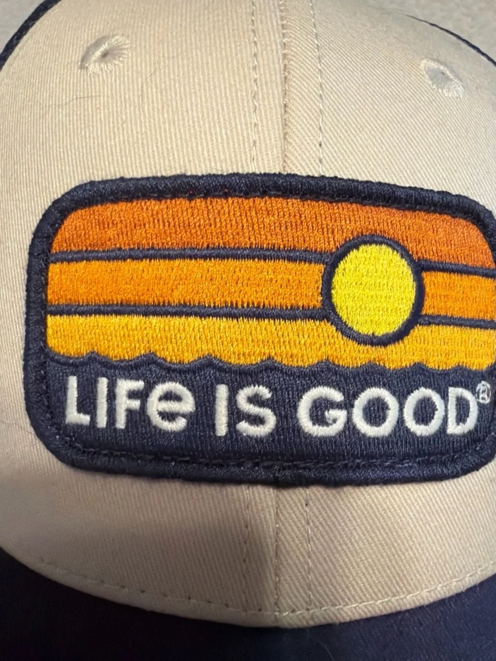 Life Is Good Cream and Navy Patch Trucker Hat with Sunset Logo